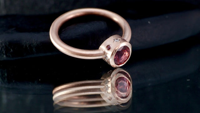 9. Robyn Clarke, Lagunas Ring 2, Laguna Colorado, 9ct rose gold, 6mm round pink tourmaline, 4 x 1.5mm FG/SI diamonds, 4 x 1.2mm Padparadscha sapphores, size M
