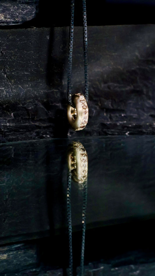 14. Robyn Clarke, Birrarung Torus Pendant, 3mm round 9ct yellow gold torus set with cognac, champagne and white diamonds, on 45cm oxidised sterling silver chain