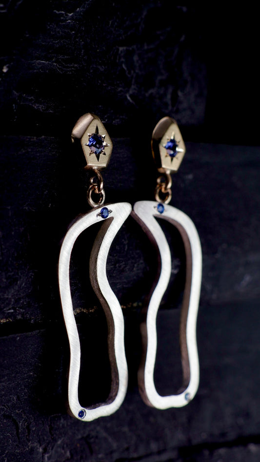 16. Robyn Clarke, Birrarung Cormorant Earrings, 9ct yellow gold carved rock-  shaped studs set with bright blue sapphires, with sterling silver drops set with small bright blue sapphires