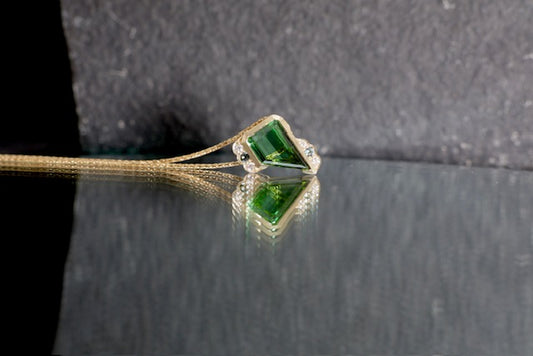 18. Robyn Clarke, Mystic Weight Pendant 1, 9ct yellow gold with a 1.31ct trapezoid green tourmaline, 2 x 1.5mm teal sapphires, 4 x 1.0/1.3mm EF/SI diamonds, on 9ct yellow gold 45cm chain